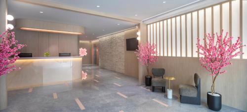 a lobby with pink trees and pink flowers at Hotel Sakura by Venue in Singapore