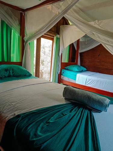 Ένα ή περισσότερα κρεβάτια σε δωμάτιο στο Alaya Ecolodge