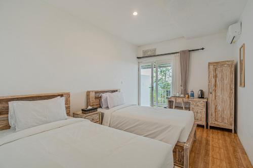 Ένα ή περισσότερα κρεβάτια σε δωμάτιο στο Santya Loka Lodge & Twin Waterfall