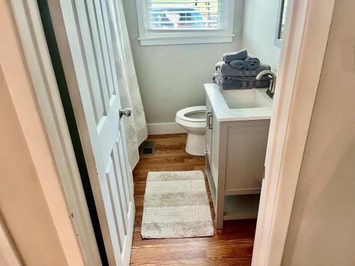 a bathroom with a toilet and a sink and a window at Family Comfort with Graceful Stays in Decatur