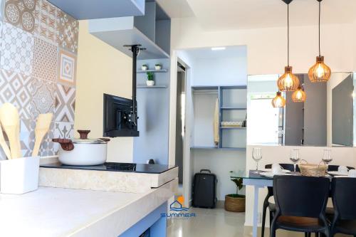 a kitchen with blue and white walls and a counter at Solar Água Pipa - Summerflats in Pipa