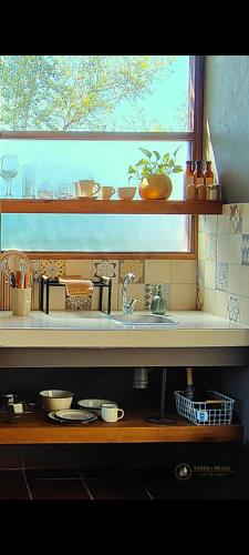 a kitchen counter with a sink and a window at Brasa Loft de Campo in Colonia Las Rosas