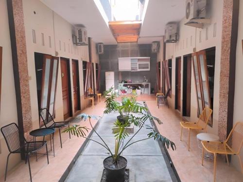 a large room with a glass table and chairs at Griya Barokah Solo in Purwosari