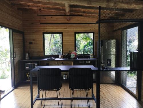 a kitchen with a table and chairs in a room at Refugio Madremonte in Medellín