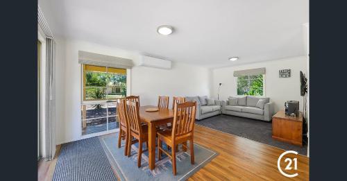 a dining room and living room with a table and chairs at Winbi River Resort Holiday Rentals in Moama