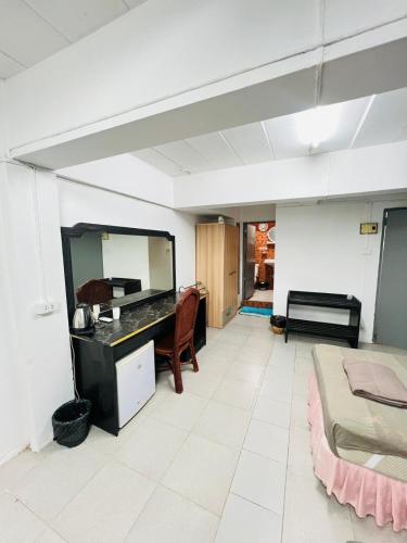 a room with a desk and a bed and a mirror at Patong Adventure Hostel in Patong Beach
