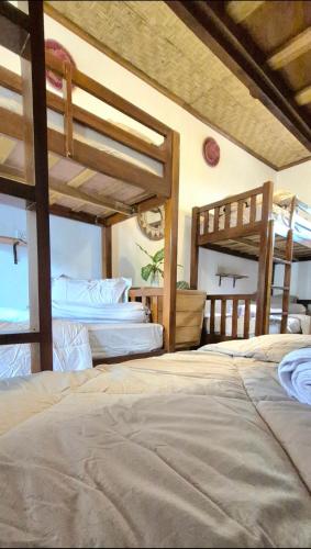 a bedroom with three bunk beds in a room at Elisa Hostel in Kuta Lombok