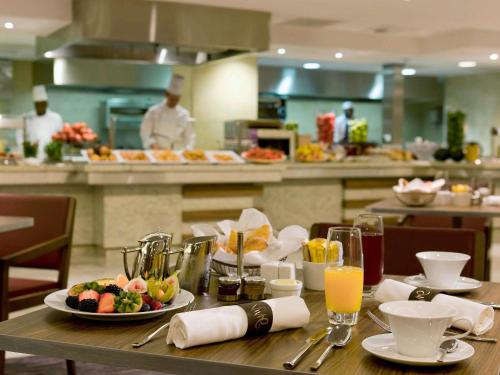 a table with plates of food on it in a restaurant at Sofitel London Heathrow in Hillingdon