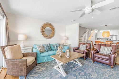 a living room with a blue couch and chairs at Blue Tide 6B in Inlet Beach