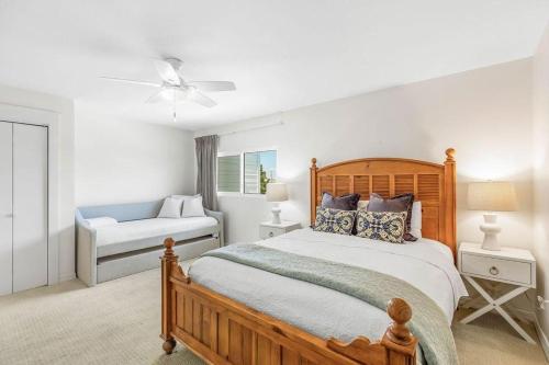 a bedroom with a wooden bed and a window at Blue Tide 6B in Inlet Beach