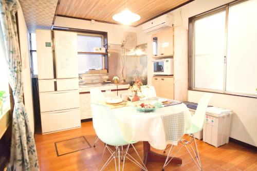 a kitchen and dining room with a table and chairs at ZENNOOK Riverside Fuji Nature Stay in Shizuoka