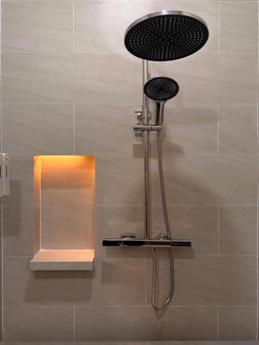 a shower in a bathroom with a mirror at Song View Pool Villa in Vang Vieng