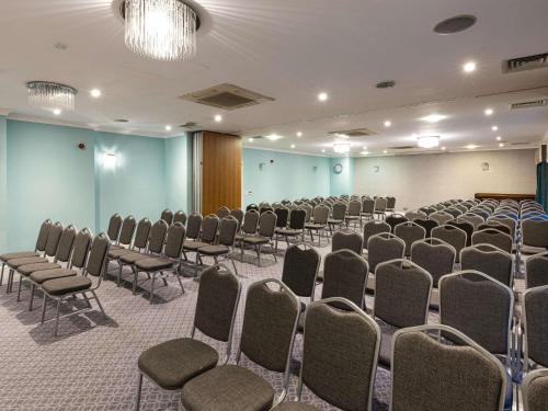 a room with rows of chairs in a room at Mercure Manchester Norton Grange Hotel & Spa in Rochdale