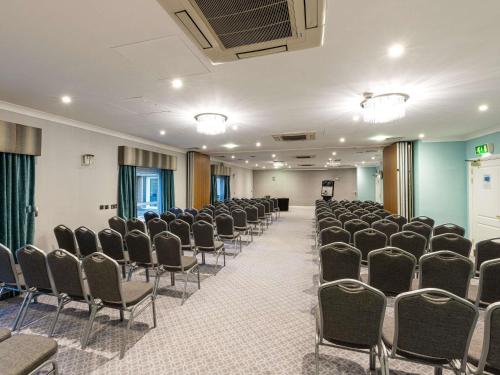 an empty room with rows of chairs in it at Mercure Manchester Norton Grange Hotel & Spa in Rochdale