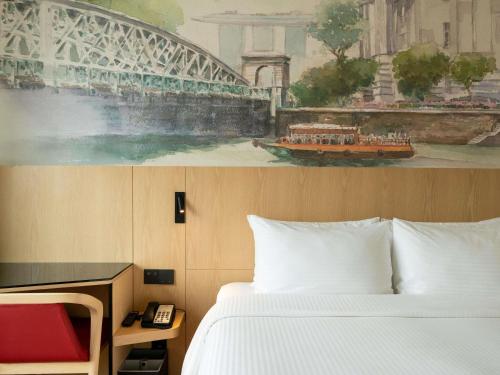 a bedroom with a bed and a painting of a bridge at Ibis Singapore on Bencoolen - Newly Renovated in Singapore