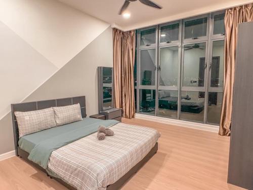 a bedroom with a bed with a teddy bear on it at Starry B19 Green Haven 2BEDROOMS l NETFLIX in Masai