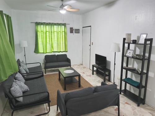 a living room with two couches and a television at Belle Go in Bauang