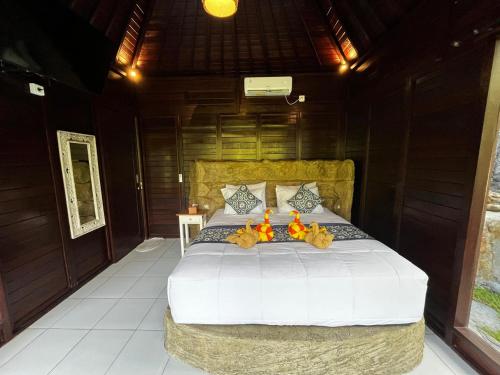 um quarto com uma cama com ursinhos de pelúcia em Cabin swargana em Tampaksiring