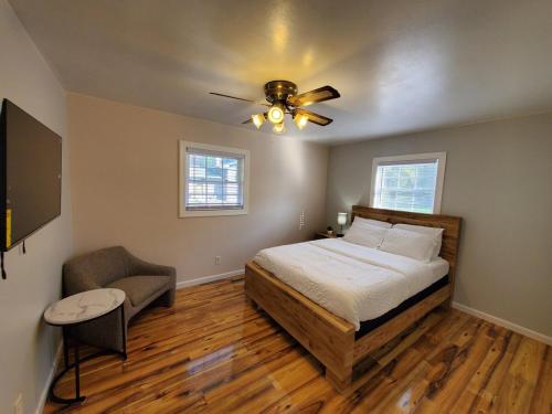a bedroom with a bed and a ceiling fan at Quiet 3BR 2BA Near Mall, Shopping Centers, and I-94 in Eau Claire