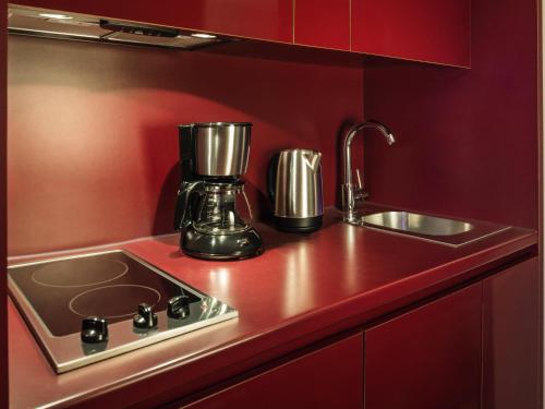 a kitchen counter with a blender and a sink at Aparthotel Adagio Paris Centre Tour Eiffel in Paris