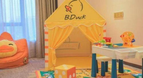 a childs play room with a play tent and a bed at Enping Yucca Hotel in Enping