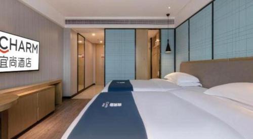 Echarm Hotel Nanning Chaoyang Square River Viewにあるベッド