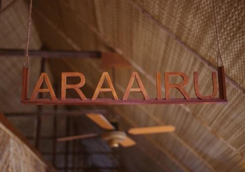 a sign that readsarma hanging from a ceiling at Makunudu Island- An Intimate Hideaway in Makunudhoo