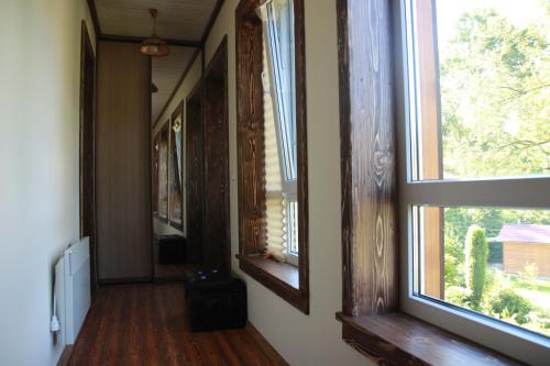 a hallway with two windows in a house at Country House Kosiv in Kosiv