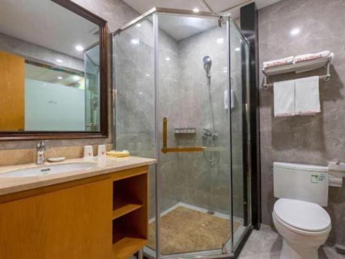 a bathroom with a shower and a toilet and a sink at Shell Hotel Changzhou North Railway Station Global Harbor Metro Station in Changzhou