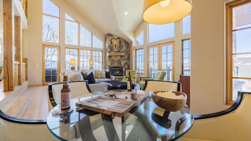 a living room with a glass table and chairs at Vail View by AvantStay Minutes from Beaver Creek in Dowds Junction
