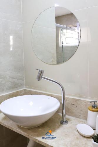 a bathroom with a white sink and a mirror at Solar Água Pipa - Summerflats in Pipa