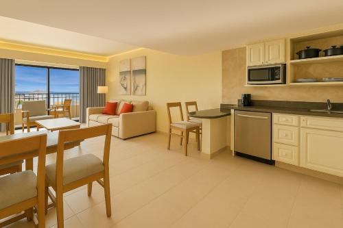 a living room with a kitchen and a dining room at Fiesta Americana Cancun Villas in Cancún