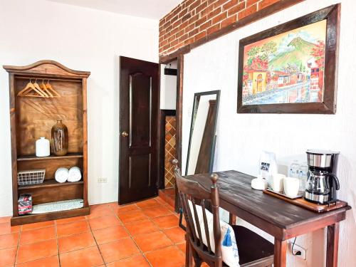 a dining room with a table and a coffee maker at Colonial House 8 rooms and private parking in Antigua Guatemala in Antigua Guatemala