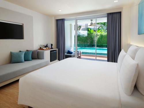 Ένα ή περισσότερα κρεβάτια σε δωμάτιο στο Pullman Pattaya Hotel G