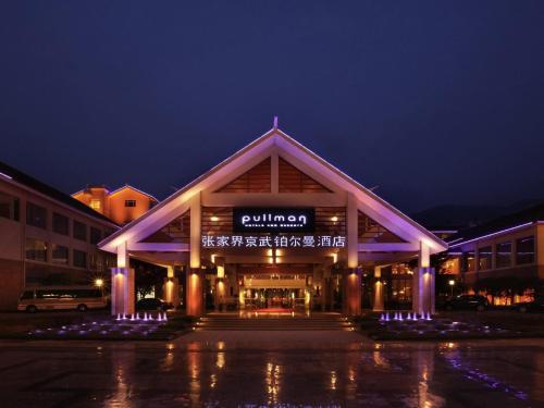a building with a sign on it at night at Pullman Zhangjiajie Hotel - Instagrammable in Zhangjiajie