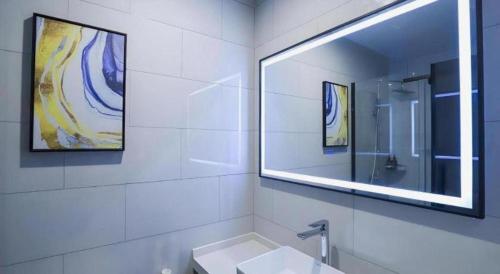 a white bathroom with a sink and a mirror at GreenTree Inn Express Fuyang University Town West High-Speed Railway Station in Fuyang