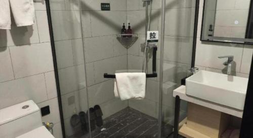 a bathroom with a shower and a sink at GreenTree Inn Express Fuyang University Town West High-Speed Railway Station in Fuyang
