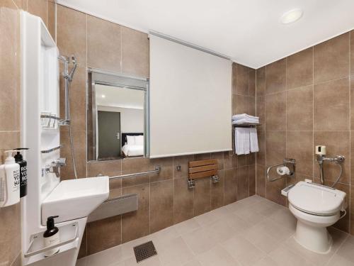 a bathroom with a toilet and a sink and a mirror at ibis Ambassador Seoul Insadong-Newly renovated in 2025 in Seoul