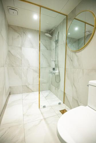 a bathroom with a shower and a toilet at JungWon Hotel in Incheon