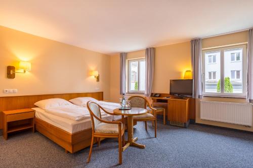 Postel nebo postele na pokoji v ubytování Kurhaushotel Bad Salzhausen