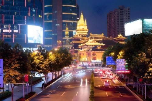 a city at night with traffic on a busy street at Shanghai Jinchen Hotel in Shanghai