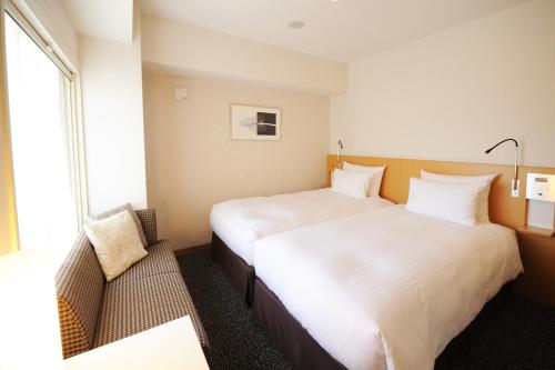 Postel nebo postele na pokoji v ubytování Hotel Sunflex Kagoshima