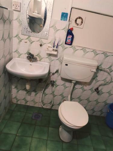 a bathroom with a toilet and a sink at Heranya hostel in Jawlakhel