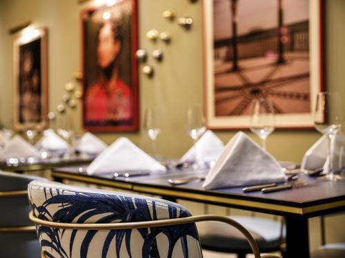 a chair sitting in front of a table in a restaurant at Mercure Brighton Seafront Hotel in Brighton & Hove