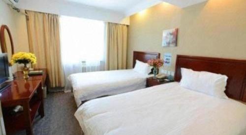 Ένα ή περισσότερα κρεβάτια σε δωμάτιο στο GreenTree Inn Wuhu Eshan Road University City