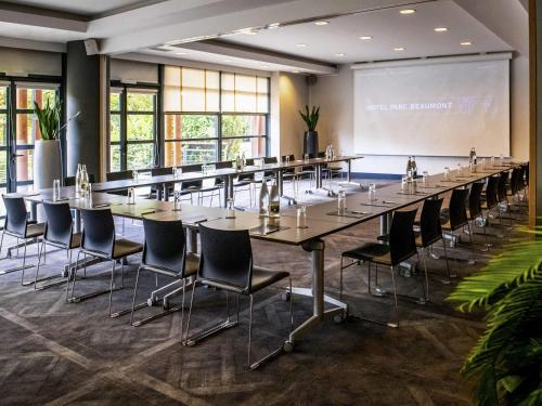 a large conference room with a long table and chairs at Parc Beaumont Hôtel & Spa Pau - MGallery Collection in Pau