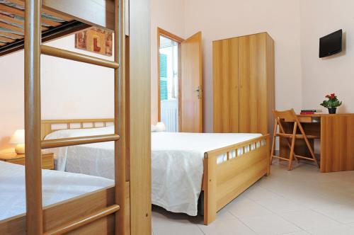 Un pat sau paturi într-o cameră la Sporting Hotel Stella Maris