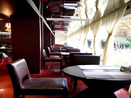a row of tables and chairs in a restaurant at Huangshan Shuguang Yusong Hotel in Huangshan