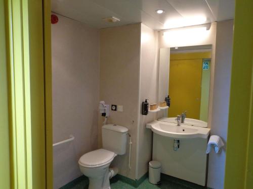 a bathroom with a toilet and a sink at ibis styles Dax Centre in Dax