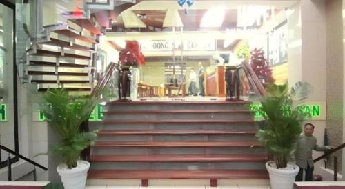 a man walking down a set of stairs in a store at An Dong Center Hotel Chinatown Saigon in Ho Chi Minh City